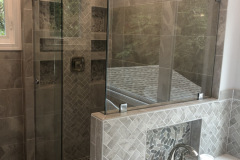 Custom  Skyline shower sliding door with return panel brushed stainless hardware and clear tempered glass