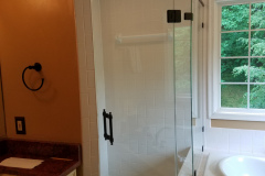 Custom 3/8" Clear tempered shower door with inline panel and return.